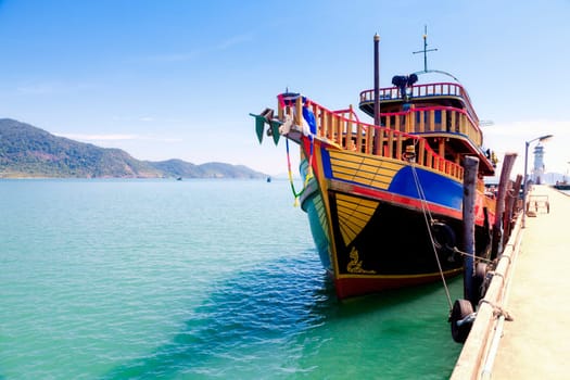 Traditional Thai tour boat tied at the pier on Koh Chang Island in Thailand