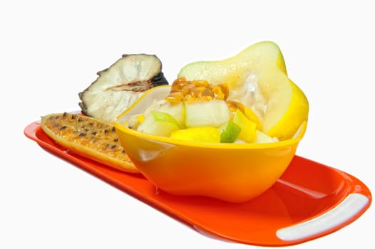 salad with tropical fruits on white background