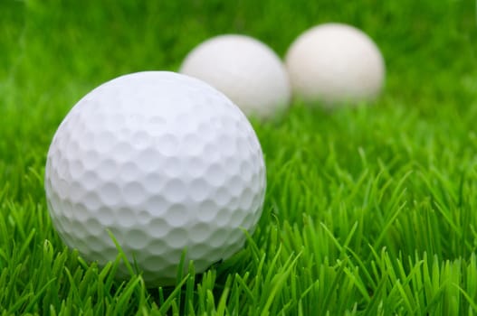 Group of Golf Balls in Green Grass
