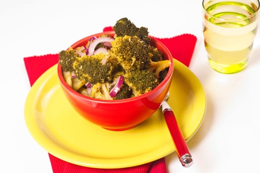 Broccoli and red onion salad in red skin