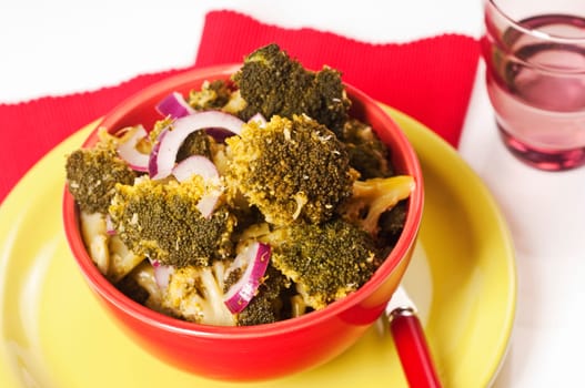 Broccoli and red onion salad in red skin
