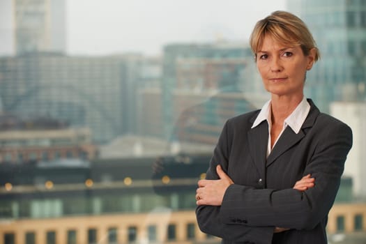 Portrait of a senior executive by a window looking at camera with space for copy