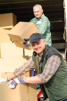 Male mover loading van with cardboard box delivery service