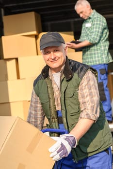 Male mover loading van with cardboard box delivery service