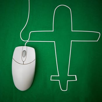 An computer mouse and airplane concept - booking a flight online