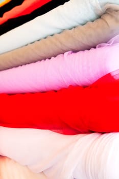 A background of various rolls of cloth