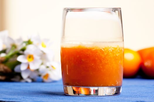 A fresh orange smoothie made with fresh fruit
