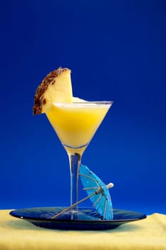 A refreshing summer drunk - pina colada over a blue background