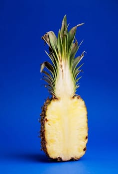 Half of a pineapple isolated on blue