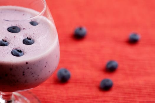 A delicious blueberry smoothie over a red cloth background