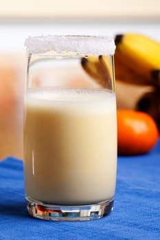 A smoothie made from oranges and bananas in an elegant glass