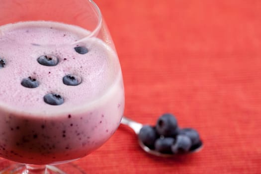 A delicious blueberry smoothie over a red cloth background