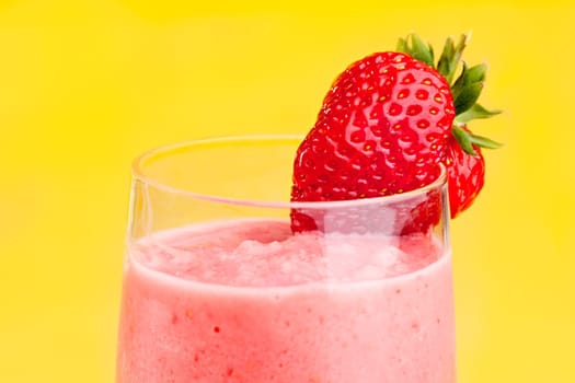A fresh strawberry smoothie isolated over yellow