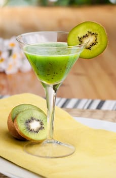 A kiwi based fruit drink in a martini glass
