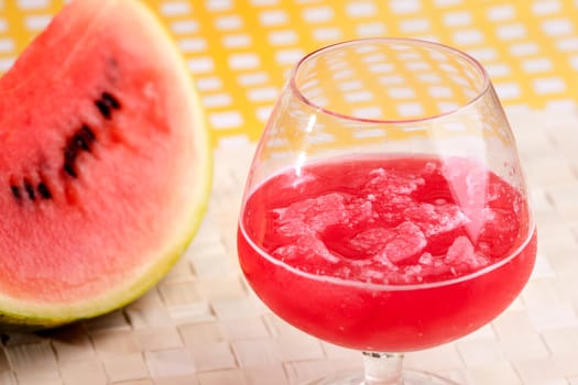 A red watermelon drink on a picnic table