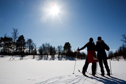 Two women in a winter landscape cross country skiing