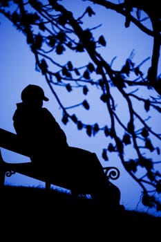 A person sitting alone on a bench