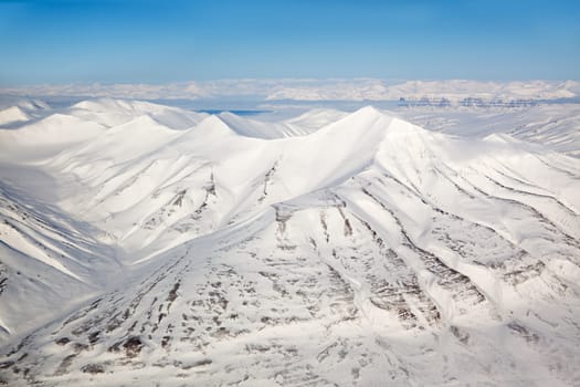 A snow covered mountain range in Svalbard