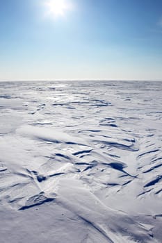 A barren winter landscape of snow and ice,