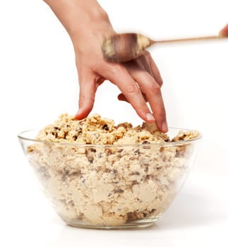 A hand reaching for cookie dough and getting caught