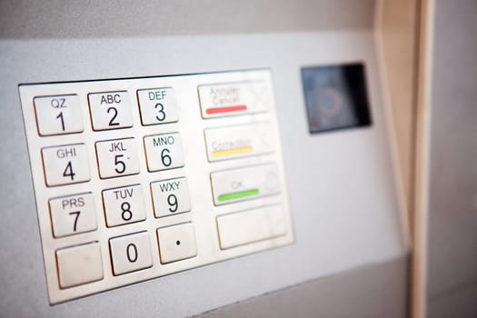 A close up detail of an outdoor bank machine  shallow depth of field with critical focus on middle row of numbers