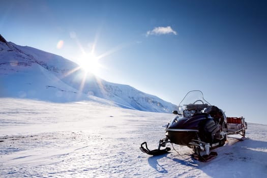 A snowmobile in a winter mountain landscape