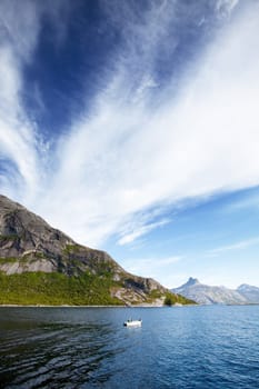 A Norwegian fjord with a small white boat