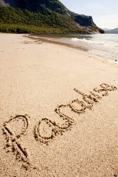 Paradise written in the sand on a beautiful island.