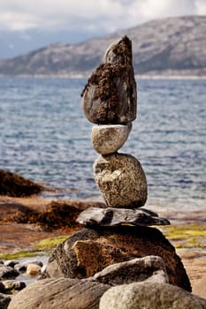 A rock stacking sculpture statue on a Norwegian landscape