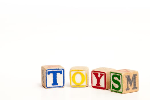 Toy blocks isolated on white spelling the word toys