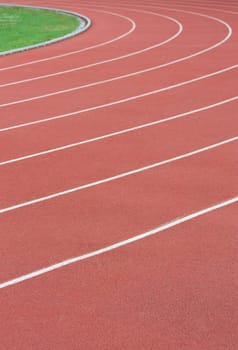 Athletics track with its lane, white lines and turn