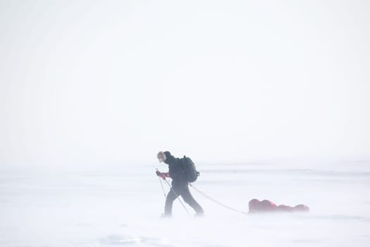 A single person on a winter expedition in a snow storm