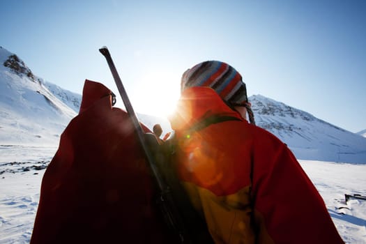 A portrait of a female adventurer against a mountain landscape
