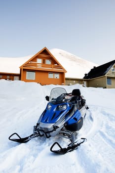 A detail of Longyearbyen, Svalbard, Norway.  A row of houses and a mountain in the distance.