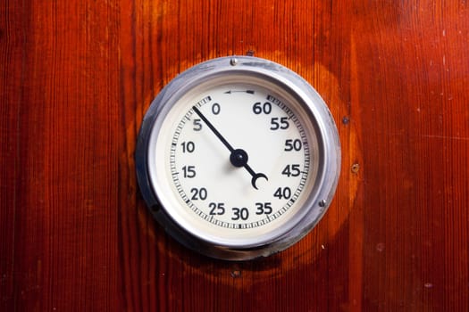 Detail of a retro manual timer attached to a wood background
