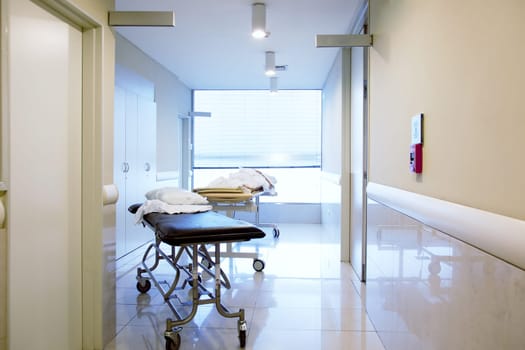 An intrior of a hospital hallway with a couple stretchers