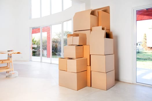 A stack of moving boxes in a new house, ready to unpack