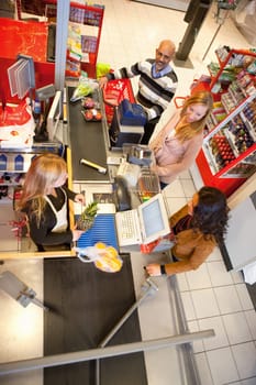 High angle view of shop assistant with customer in supermarket