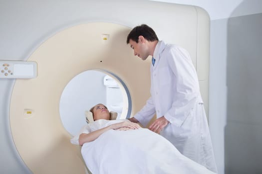 Doctor examining patient before CT scan