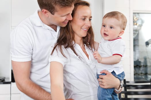 Young couple standing with their cute child