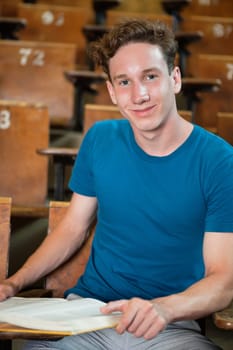 Portrait of young boy sitting in lecture hall