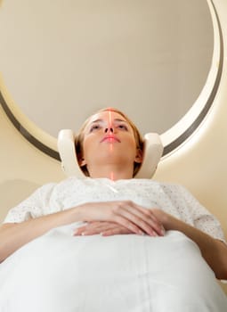 A woman having a CT scan taken - laser is on and ready