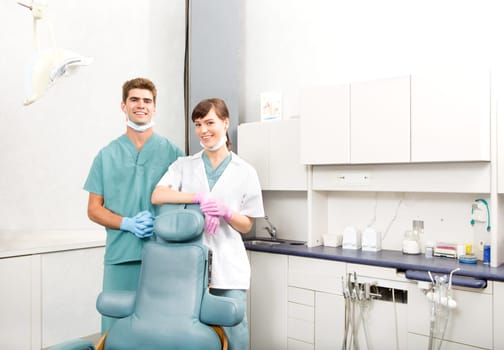 A portrait of a dental team in a clinic smiling at the camera