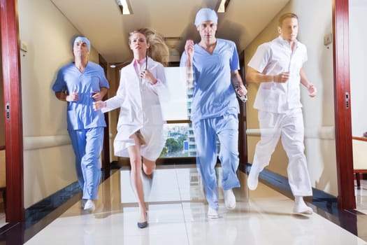 Doctor and nurse running in hallway of hospital