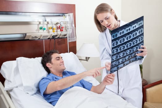 Doctor showing X-ray report to the smiling patient