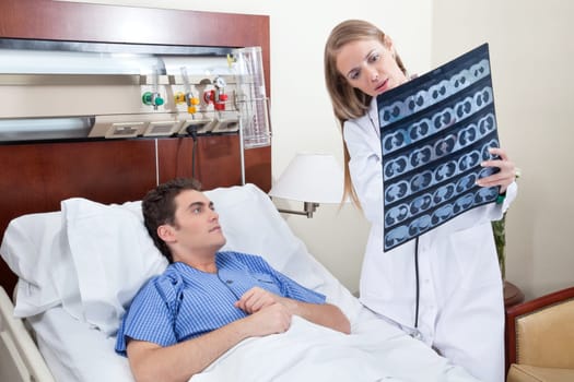 Doctor and patient examining X-ray report in hospital