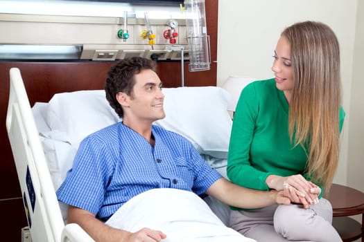 Young couple looking at each other in hospital