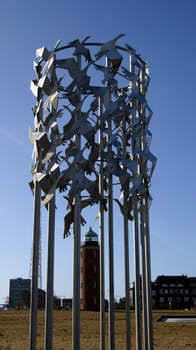Bird flight,artwork,with lighthouse/Cuxhaven