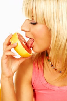Happy beautiful women with holding and licking grapefruit