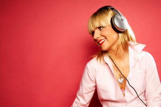 Young beautiful happy women listening music in headphones